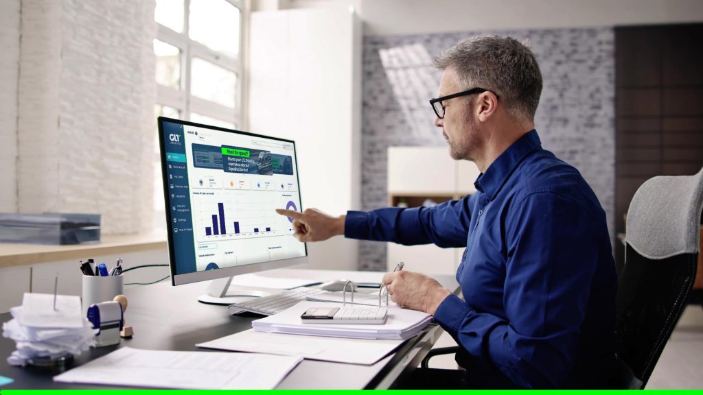 Man using online freight platform to analyze logistics data on desktop screen