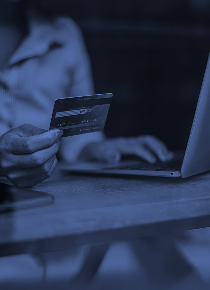Person holding credit card and laptop